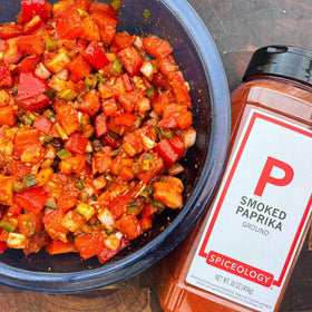 Spiceology Smoked Paprika Powder on a spoon ready to season vegetables.