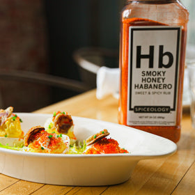 Spiceology Smoky Honey Habanero ribs on grill with caramelized crust.