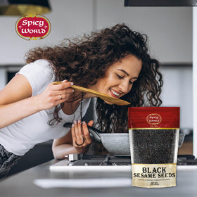 Spicy World black sesame seeds on salad, elevating texture and nuttiness.