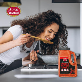 Cayenne powder in a simmering sauce highlighting versatile heat from Spicy World