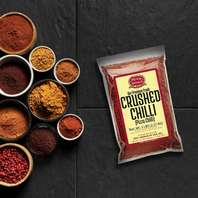 Spicy World crushed red pepper in vacuum sealed bag highlighting freshness and value.