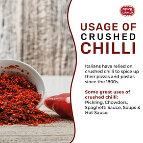 Pouring crushed red pepper over pasta to boost aroma and heat.