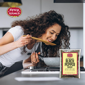 Spicy World ground pepper dusting over pasta for depth of flavor