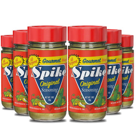Spike Original Seasoning bottle being poured, a versatile flavor enhancer for poultry and vegetables.