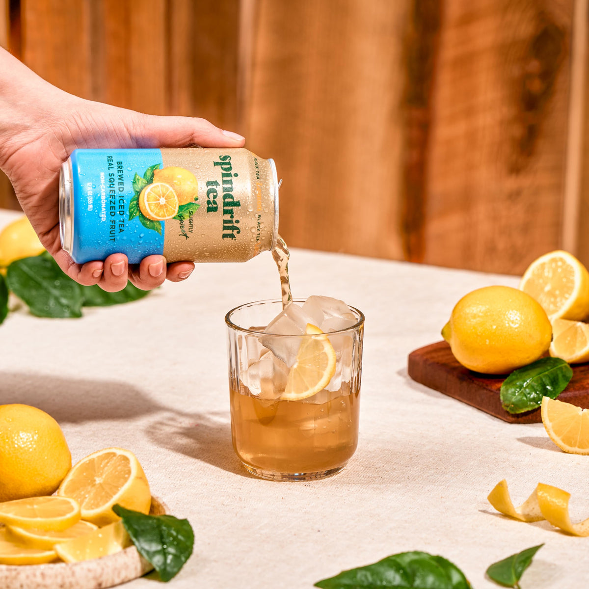 Spindrift Lemon Black Tea chilled can in hand conveys quick, on-the-go refreshment.