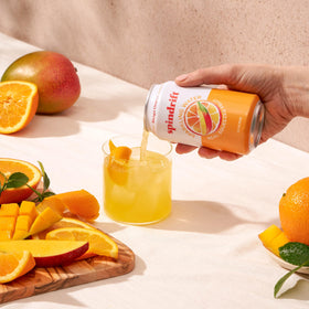 Spindrift Mango Orange glass serve illustrating lightly carbonated, pulpy texture