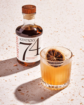 Spiritless Kentucky 74 in glass reveals notes of caramel, vanilla, oak, with light finish.