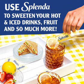 Splenda zero-calorie packets in a coffee cup for a sugar-free morning boost.