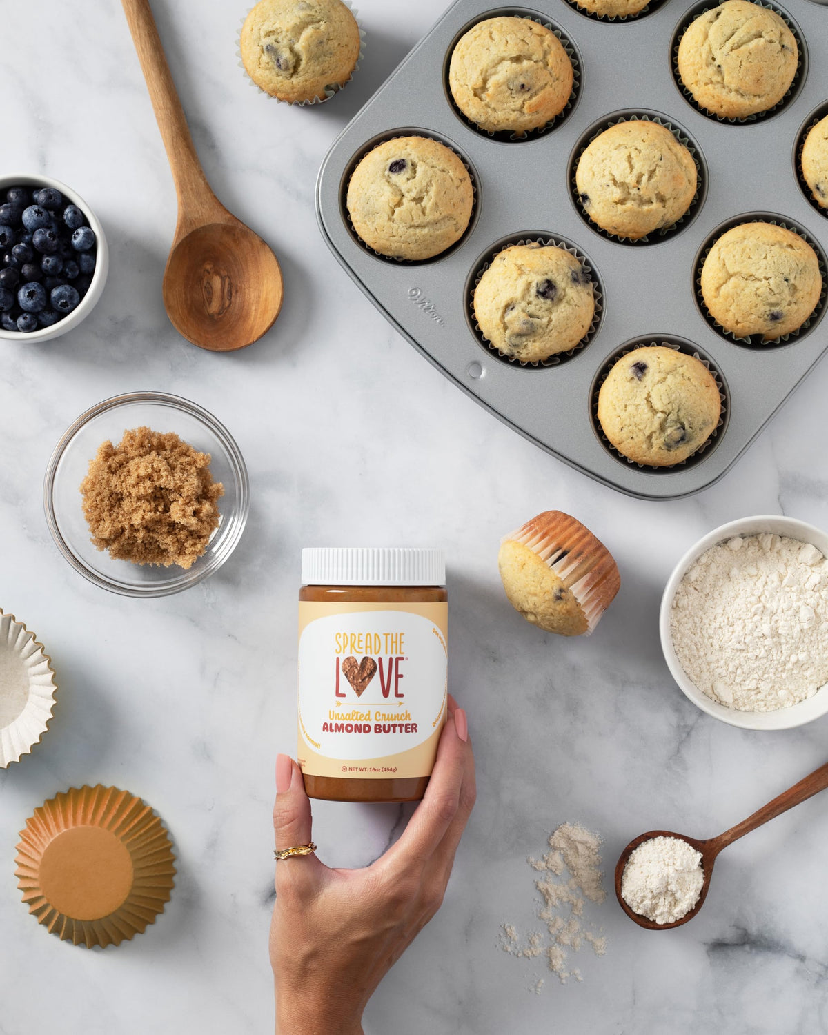 Spread The Love Unsalted Crunch Almond Butter on the kitchen counter with a natural, clean label