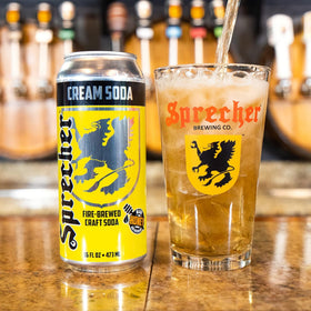 Sprecher fire-brewed soda kettle pour showing rich caramel depth