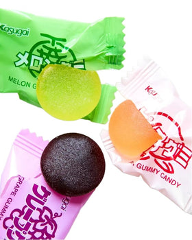 Assorted grape and strawberry gummies show colorful texture for sharing.