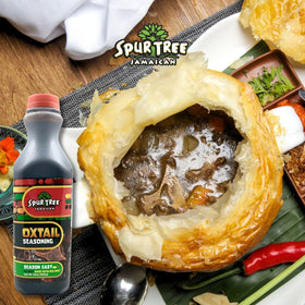 Spur Tree Oxtail Seasoning bottle pouring into pot