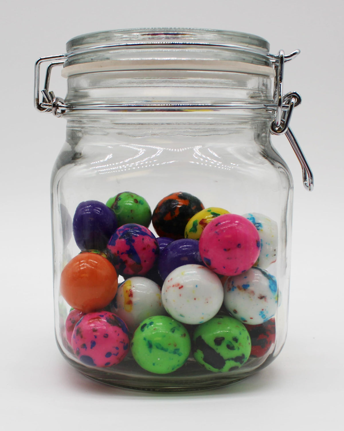 Close-up of glossy candy surfaces; Squireboone Jawbreakers add color to desserts.