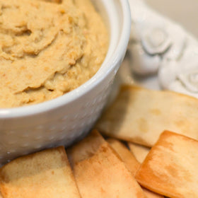 Stacy's Pita Thins variety pack on table suggests versatile snacking options for gatherings.