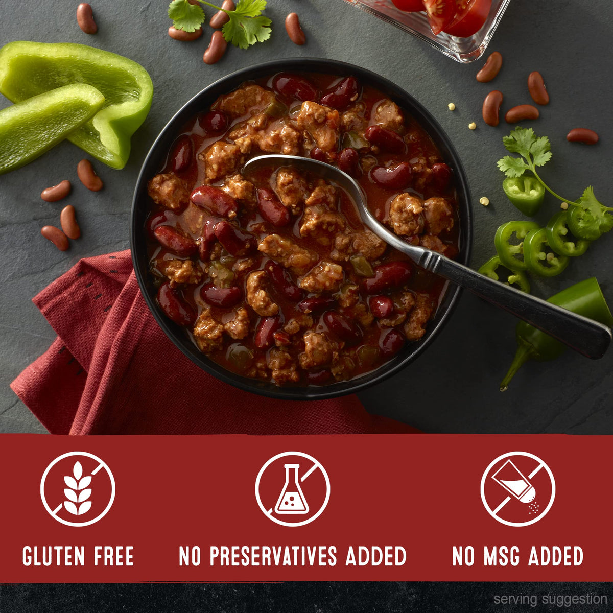 Chili topping hot dogs and sliders at a casual gathering.
