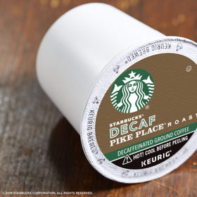 Starbucks Decaf Pike Place Roast K-Cup pod closeup highlights smooth flavor.