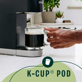 K-Cup box of Starbucks Brown Sugar Cinnamon with 60 pods beside a brewer.