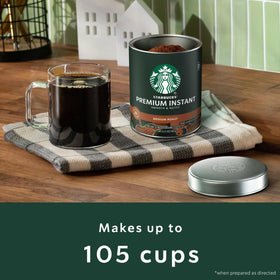 Starbucks mugs and packaging beside tins, ready for on-the-go enjoyment.