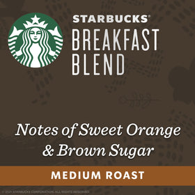 Starbucks Breakfast Blend capsules in hand, ready to brew at home.