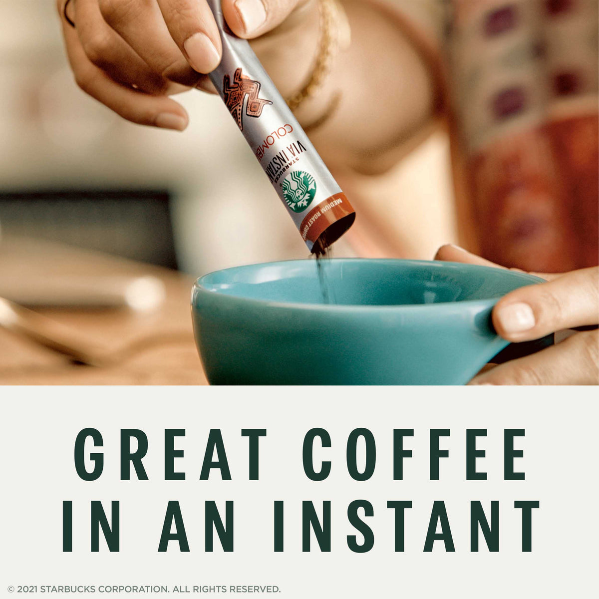 Pouring hot water over a VIA French Roast packet for a quick cup.