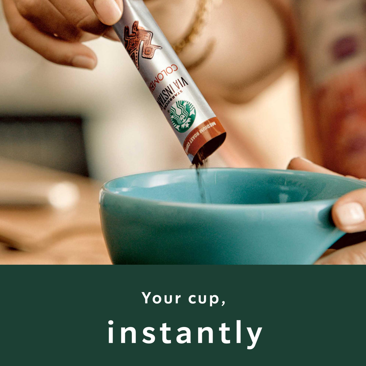 Starbucks VIA instant packets with stirred coffee evoke quick morning ritual.