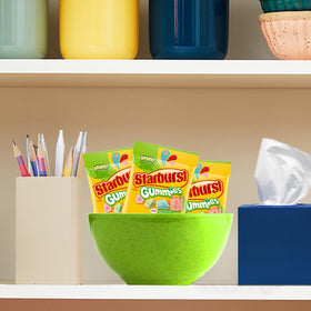 Starburst Sours Gummies office desk display suggests quick mood-lifter.
