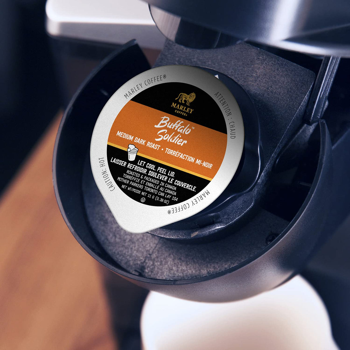 Steaming cup with Marley Coffee Buffalo Soldier capsules ready for brewing.