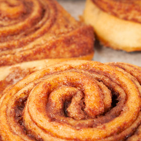 Stern’s Bakery cinnamon rolls shown at a gathering, perfect for sharing.
