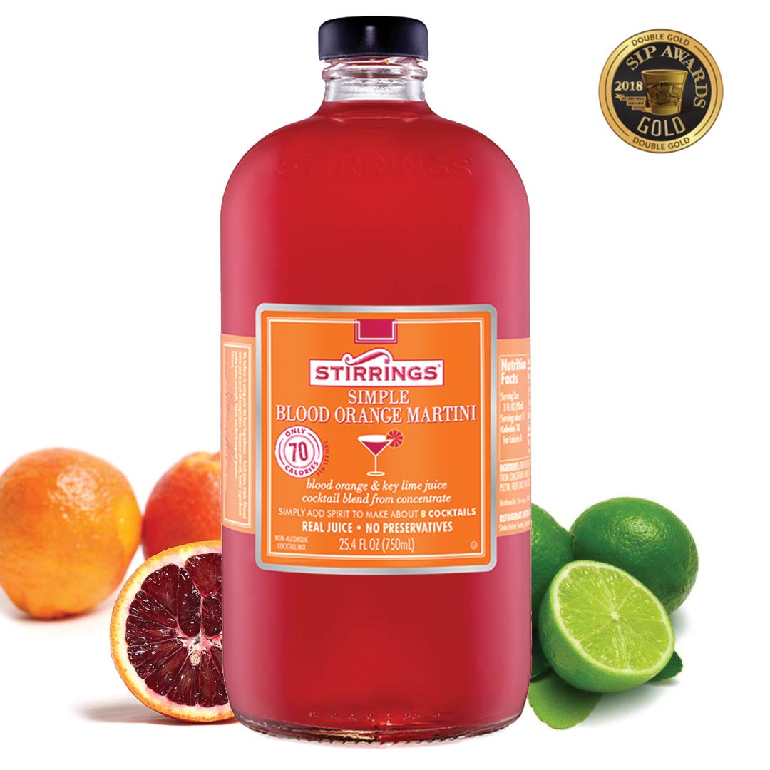 Stirrings Blood Orange Martini Mix color swirls in a champagne coupe