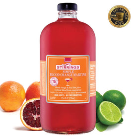 Stirrings Blood Orange Martini Mix color swirls in a champagne coupe
