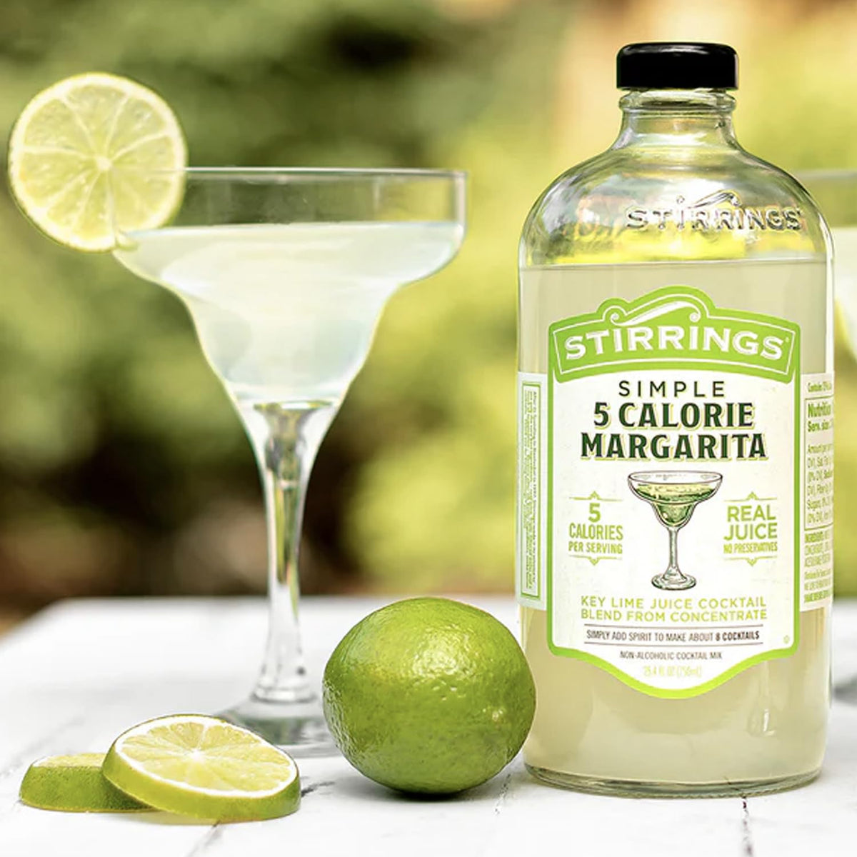 Stirrings Margarita Mix setup with glass and lime for entertaining.