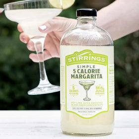 Stirrings Margarita Mix label close-up highlights real juice and no preservatives.