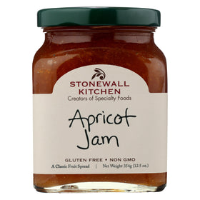 Stonewall Kitchen Apricot Jam jar on a wooden board, ready to spread on toast.