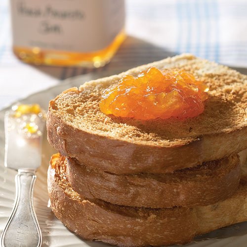 Close-up of Stonewall Kitchen Peach Amaretto Jam jar showing glossy jam.