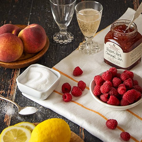 Stonewall Kitchen Raspberry Peach Champagne Jam glaze brightens fruit tarts with a hint of champagne.