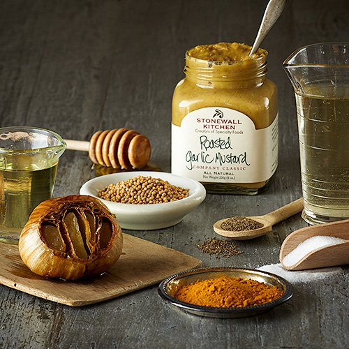 Close-up of roasted garlic in Stonewall Kitchen Mustard, creamy texture visible.