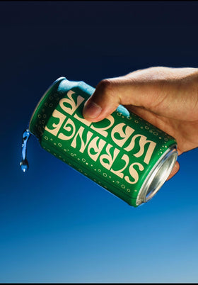Strange Water Sparkling Coconut Water 4-pack side view with label, ready to grab.