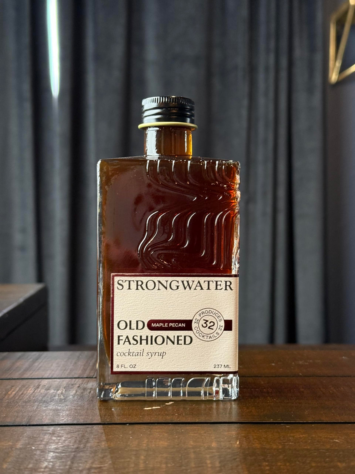 Strongwater mixer glass with Old Fashioned, showcasing rich maple and pecan notes.