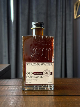 Strongwater mixer glass with Old Fashioned, showcasing rich maple and pecan notes.