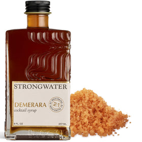 Strongwater Rich Demerara Syrup bottle on bar for elevating cocktails.