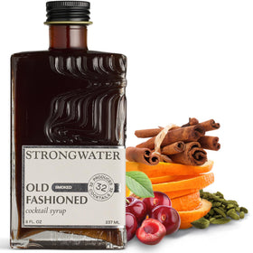Strongwater smoked old fashioned cocktail mixer bottle on a bar for premium at-home cocktails.