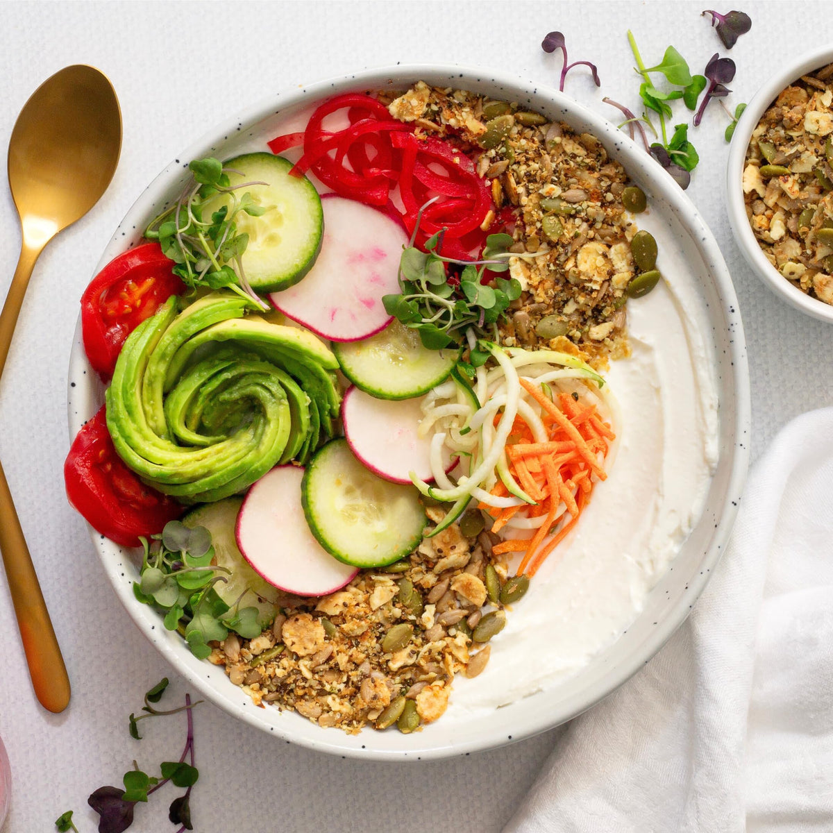 Serving bowl with Struesli Savory & Seed and yogurt for savory crunch