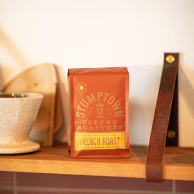 Stumptown French Roast coffee cup, deep color and potential for creamy or black brews.