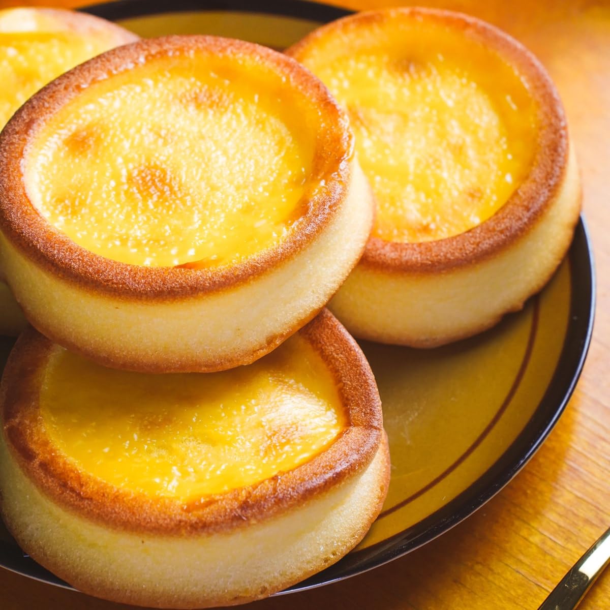 Success Imports Cake Egg Tarts crust closeup shows golden flaky layers and custard texture.