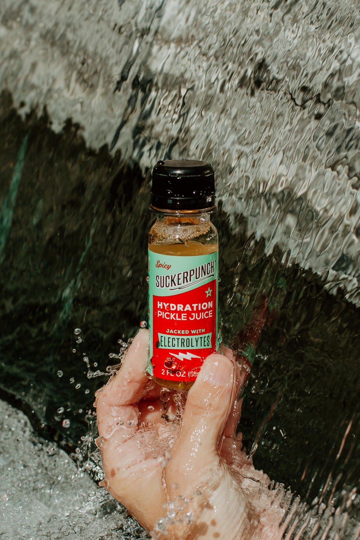 On-the-go hydration with Suckerpunch pickle juice shot during training