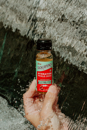 On-the-go hydration with Suckerpunch pickle juice shot during training