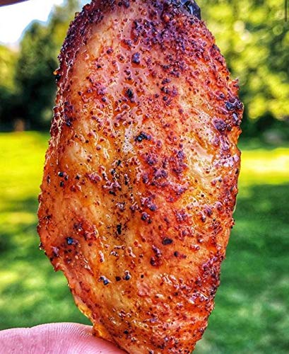 Pouring Clucker Dust over chicken reveals medium heat flavor and a glossy finish