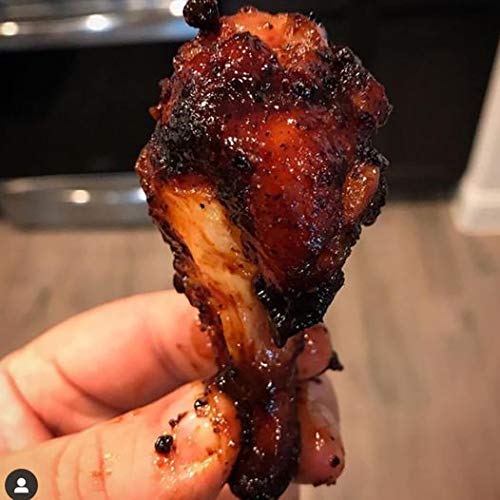 Seasoned chicken on grill with Clucker Dust for a rich red BBQ color
