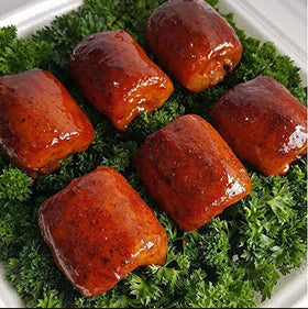 Close-up of SuckleBusters Clucker Dust shaker highlighting sweet and spicy seasoning for chicken