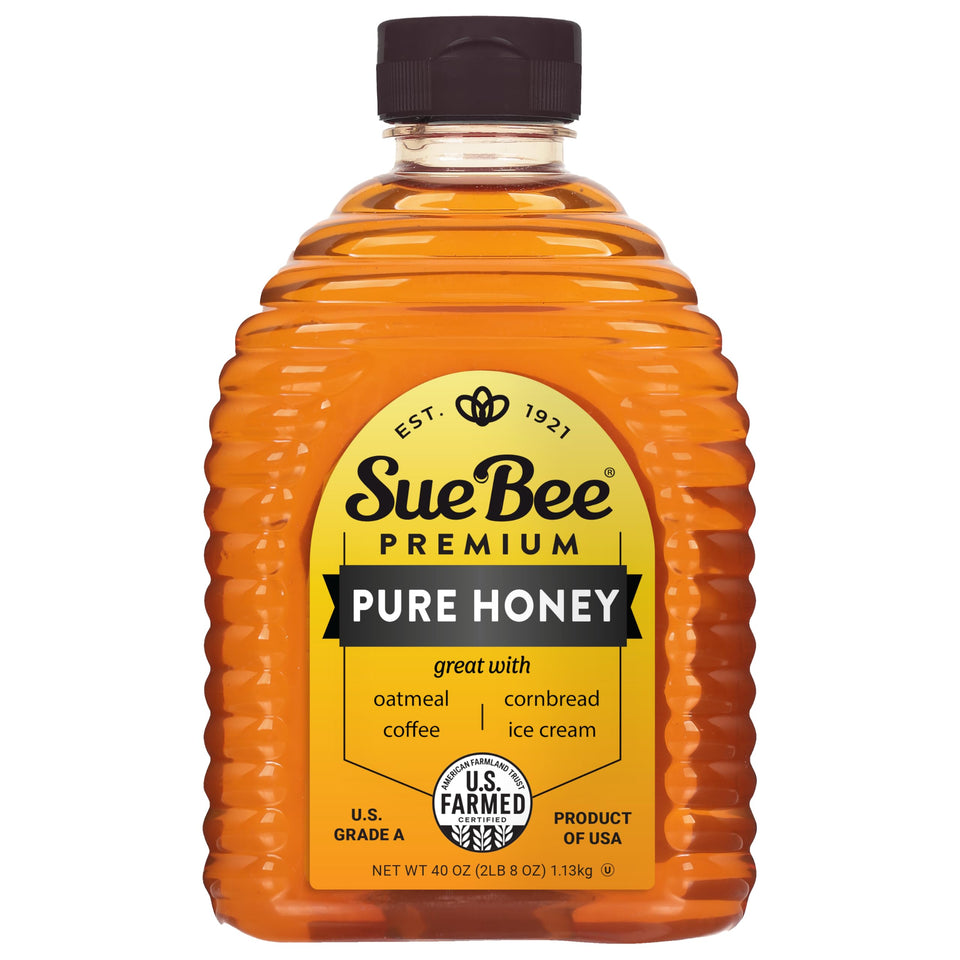 Sue Bee Pure Premium Honey bottle on kitchen counter, ideal for tea and baking.